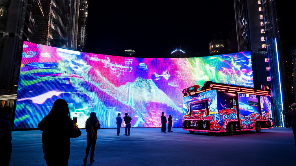 In a futuristic city, a large Coca-Cola "Coke Wagon" ad screen attracts passersby, showcasing new AI-driven advertising strategies.